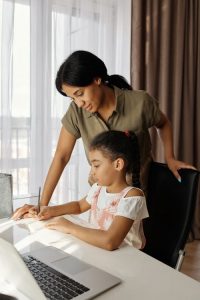 A homeschooling parent and her child studying